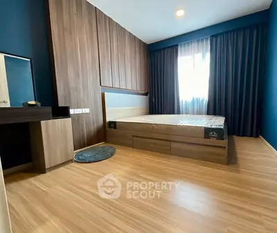 Modern bedroom with wooden flooring and stylish furnishings