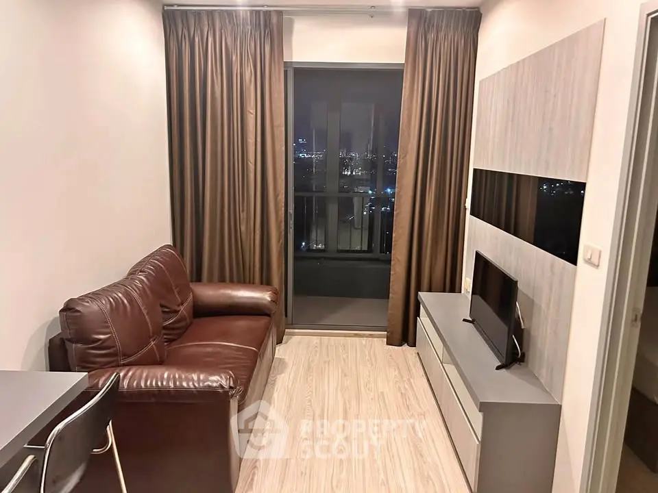 Modern living room with leather sofa and city view from balcony