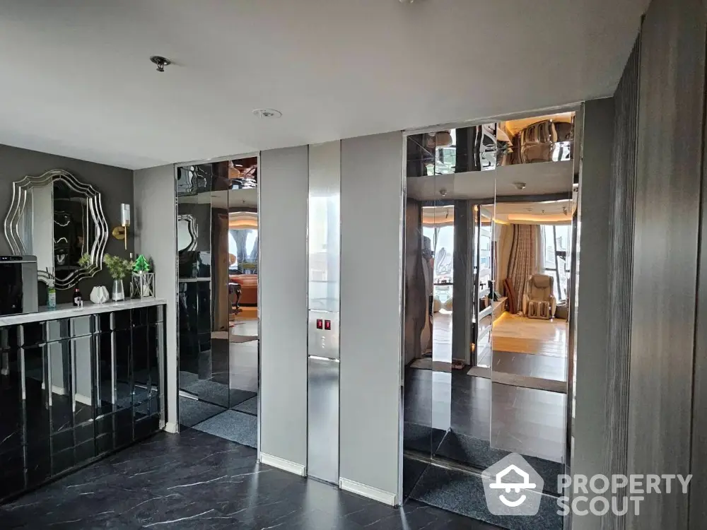 Luxurious modern elevator lobby with mirrored walls and elegant decor