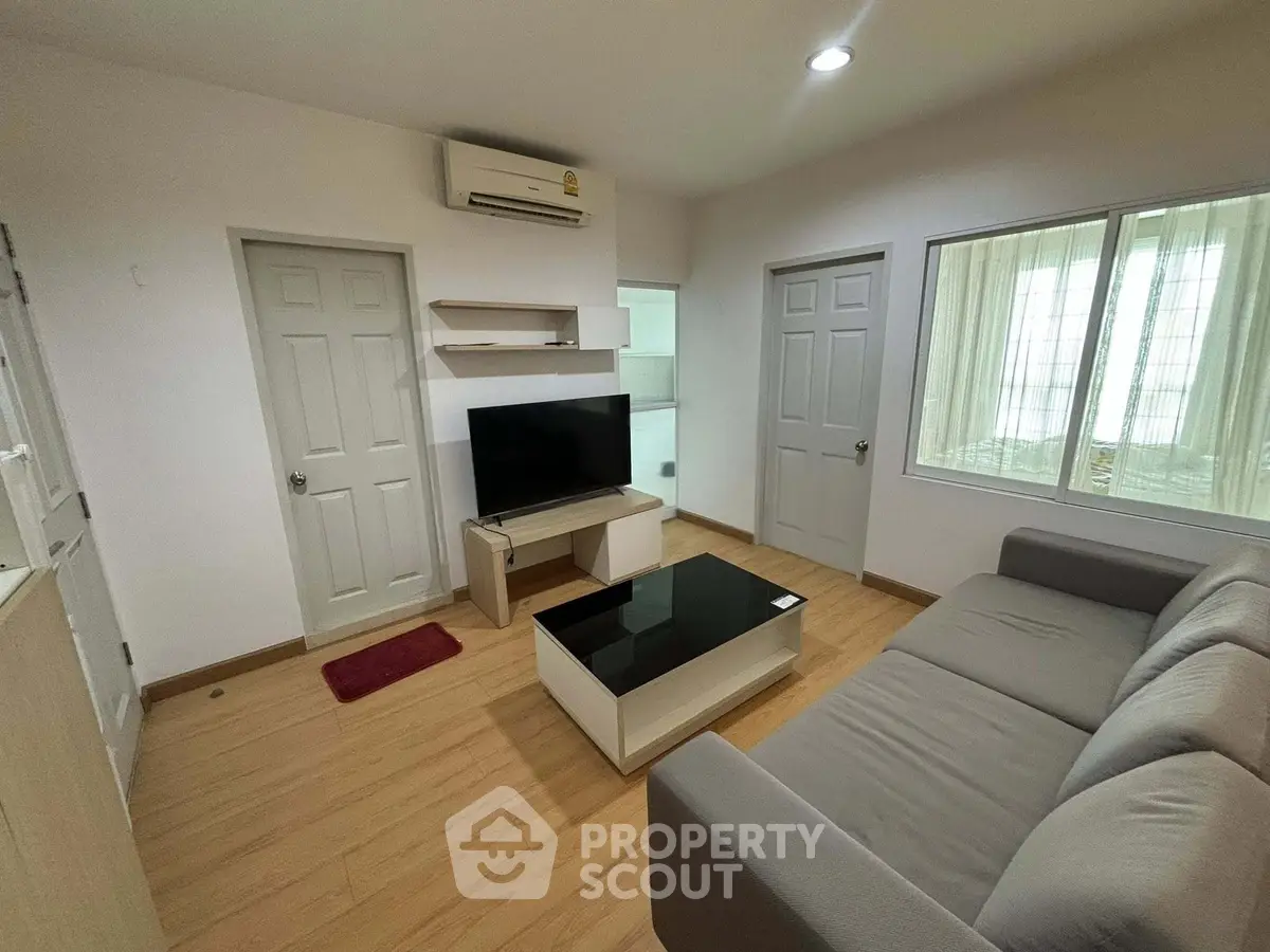 Cozy living room with modern furniture and natural light, perfect for relaxation and entertainment.