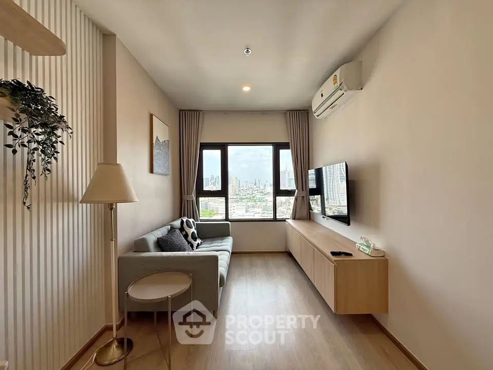 Modern living room with city view, featuring sleek furniture and air conditioning.