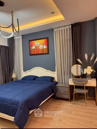 Elegant bedroom with modern decor, featuring a cozy bed, stylish vanity, and ambient lighting.