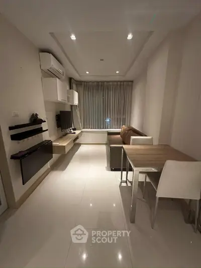 Modern living room with sleek furniture and ambient lighting, perfect for cozy gatherings.