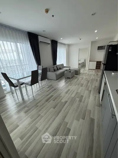 Spacious modern living room with open kitchen and elegant dining area