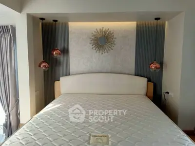 Luxurious bedroom with stylish decor and modern lighting, featuring a comfortable bed and elegant wall design.