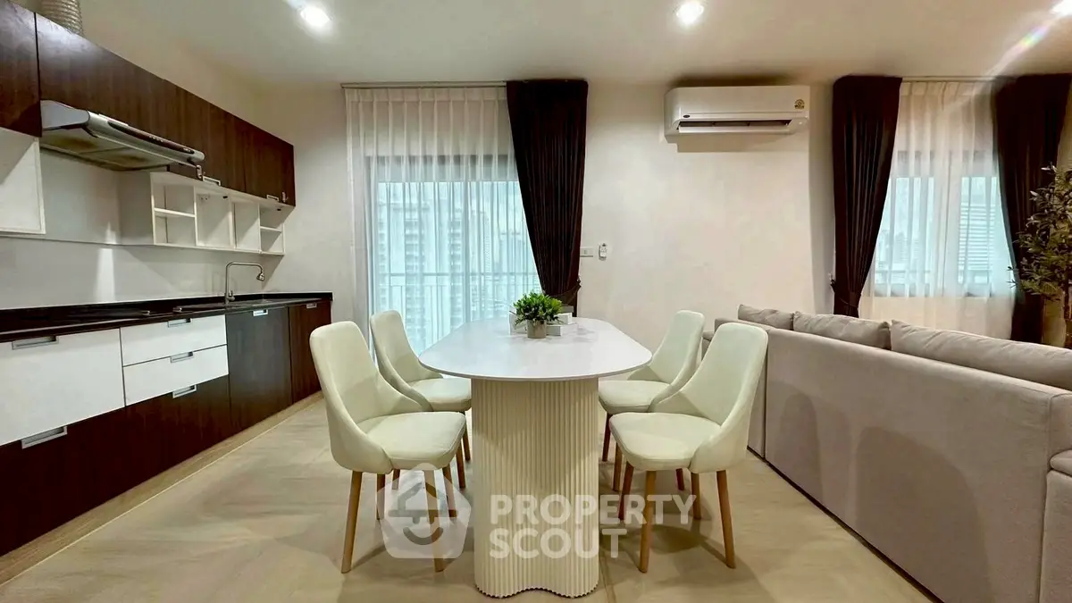 Modern open-layout kitchen and dining area with sleek design and natural light.