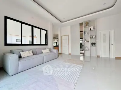 Spacious modern living room with elegant decor and large windows