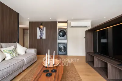 Modern living room with stylish decor and built-in laundry appliances