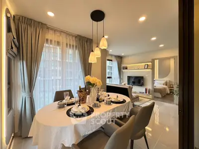 Elegant dining area with modern decor and open view to cozy living room and bedroom