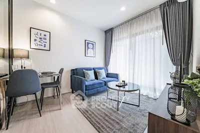 Modern living room with stylish decor, large window, and cozy seating area in a contemporary apartment.