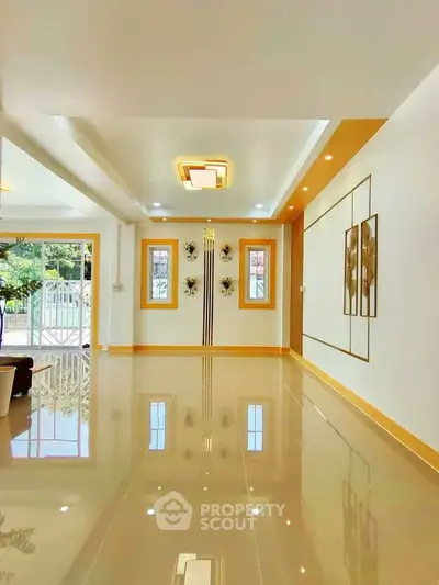 Spacious modern living room with glossy floors and elegant wall decor