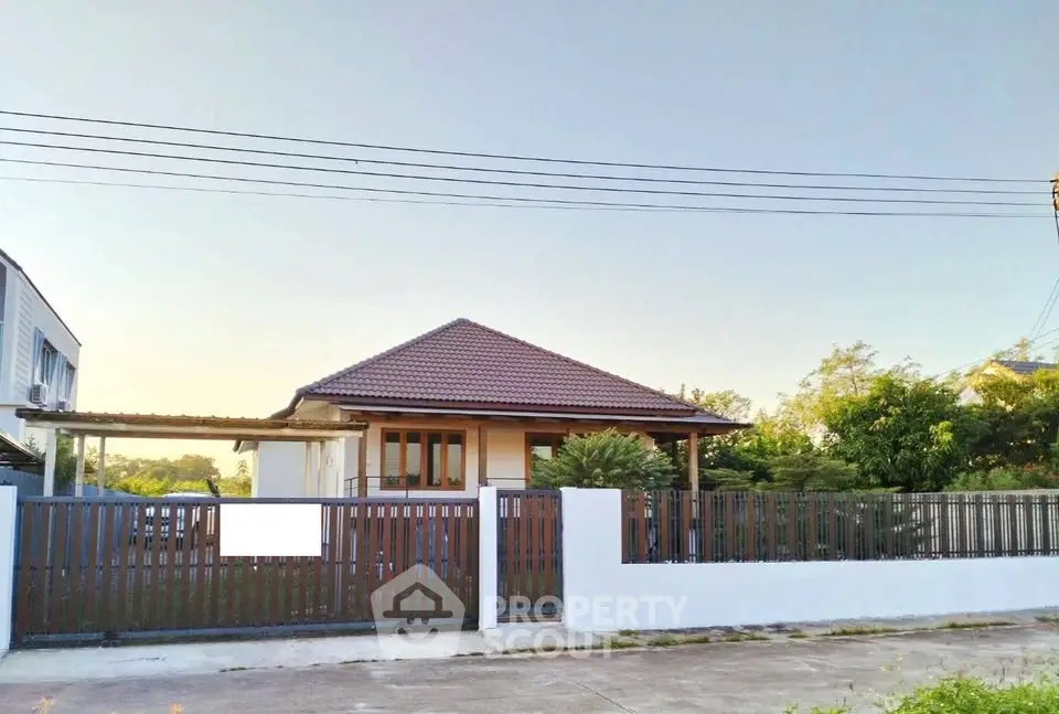 Charming single-story home with a spacious yard and modern fence in a serene neighborhood.