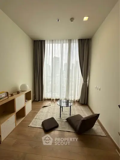 Minimalist living room with floor-to-ceiling windows and city view