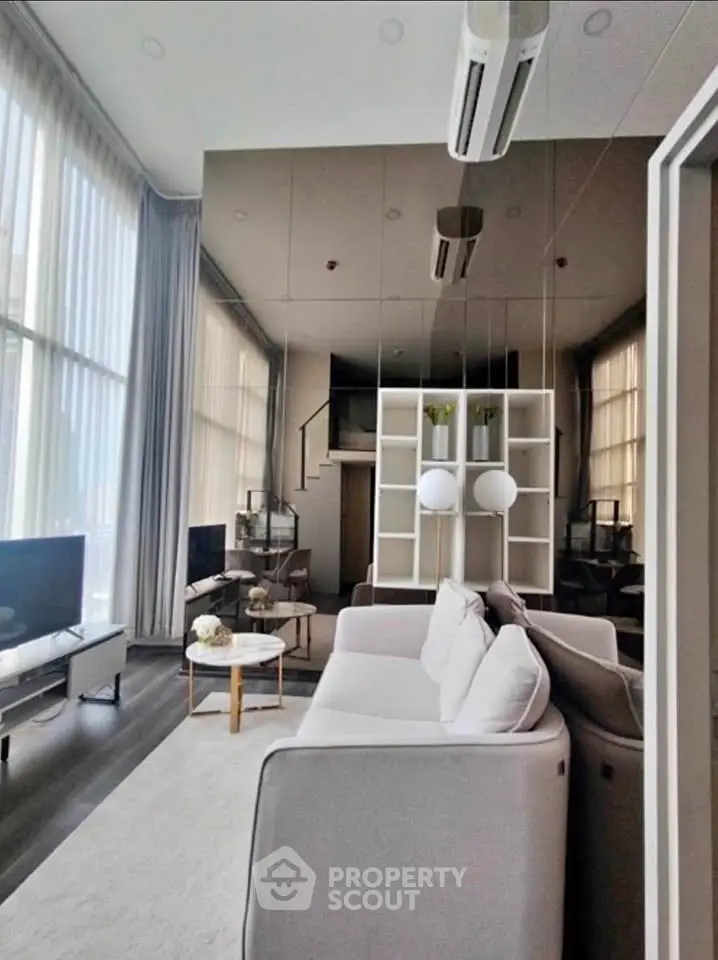 Luxurious modern living room with high ceilings and elegant decor