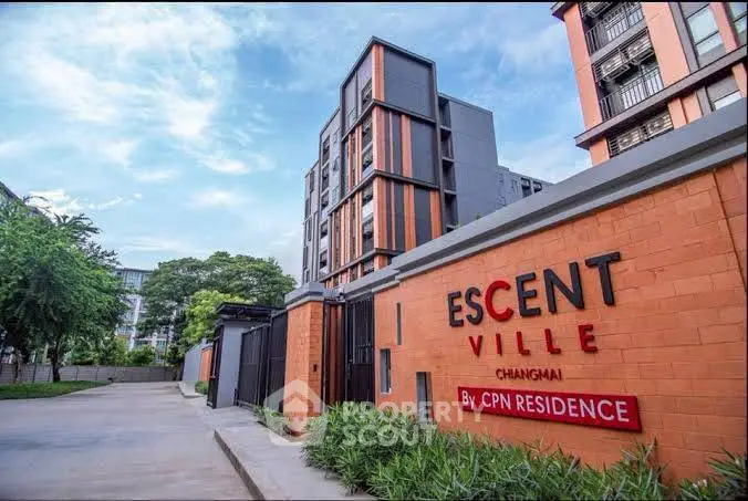 Modern residential building exterior at Escent Ville, Chiang Mai with lush greenery.