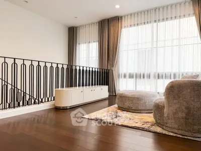 Spacious living room with elegant decor and large windows for natural light.