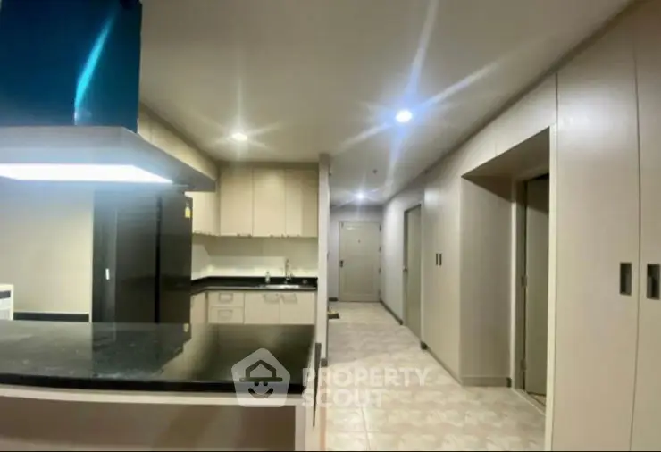 Modern building corridor with sleek design and ambient lighting.