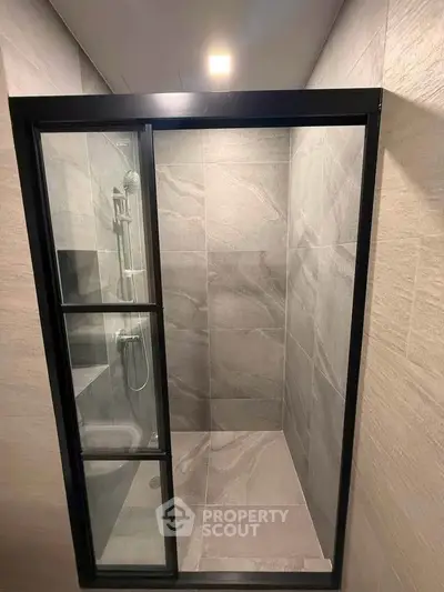 Modern bathroom shower with sleek glass door and elegant tile design