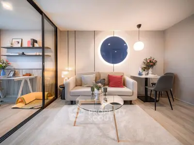 Modern living room with stylish decor and glass coffee table