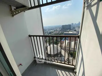 Stunning city view from a high-rise balcony with clear skies and urban landscape.