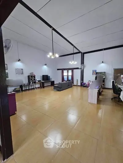 Spacious living room with high ceilings and modern furnishings, perfect for family gatherings.
