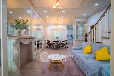 Elegant living room with plush sofa, stylish decor, and dining area in a luxurious home.
