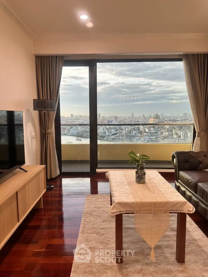 Luxurious living room with stunning city view from large glass doors, elegant furniture, and polished wooden floors.