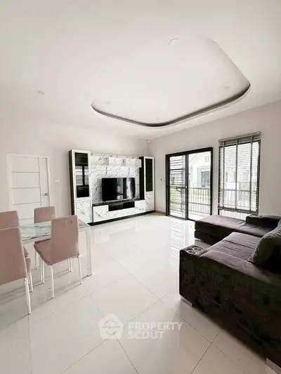 Spacious modern living room with sleek furniture and large windows for natural light.