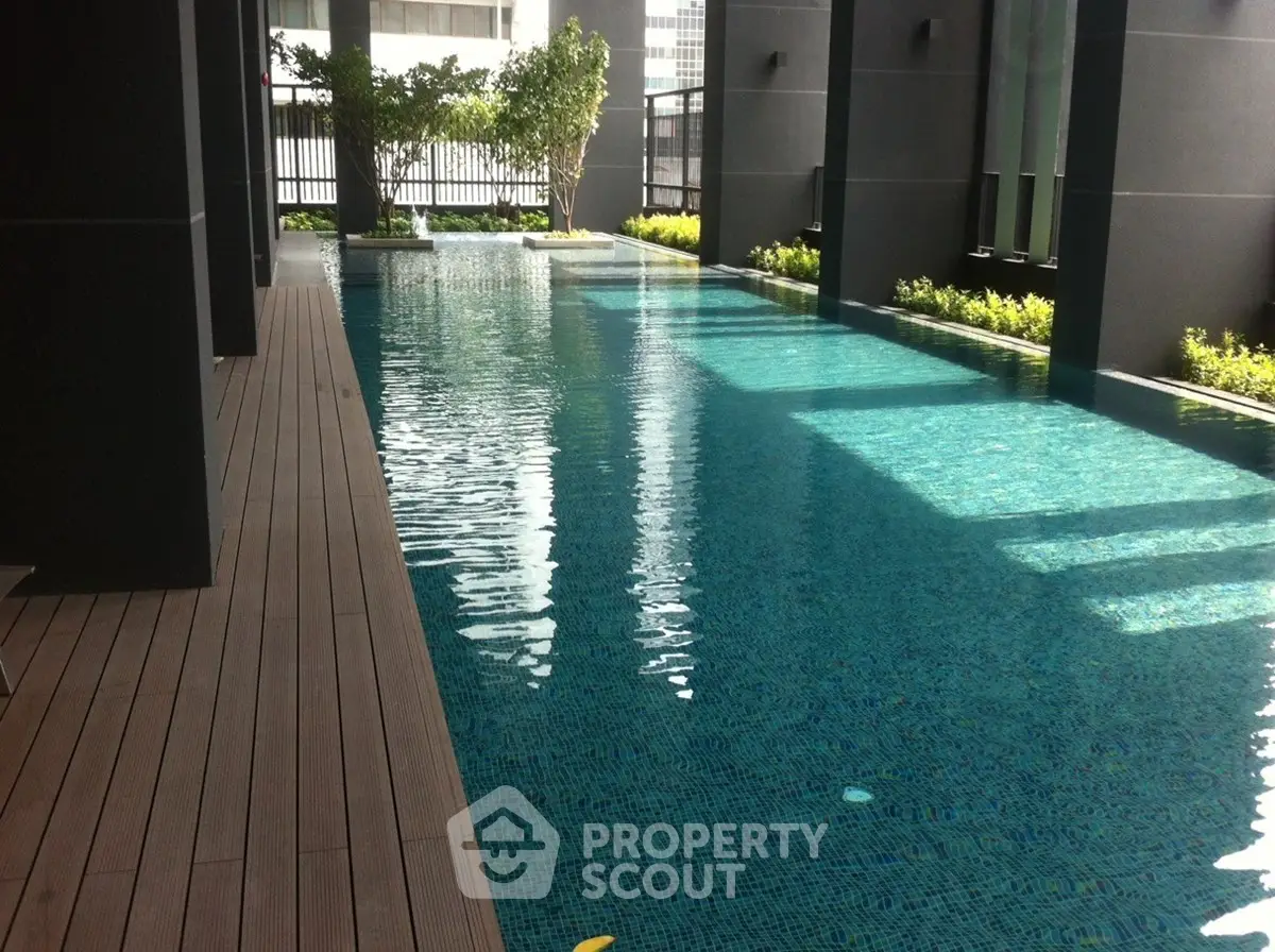 Luxurious modern apartment pool with sleek design and city views.