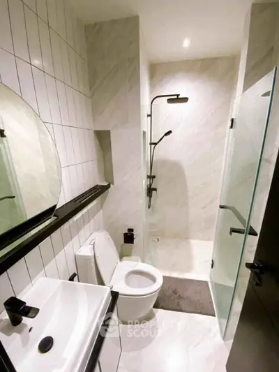 Modern bathroom with sleek shower and elegant fixtures in a stylish apartment.