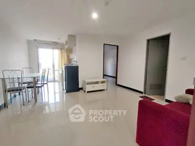 Spacious open-plan living room with dining area and modern furnishings