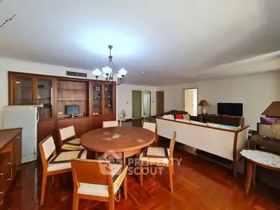 Spacious living room with elegant wooden furniture and modern lighting