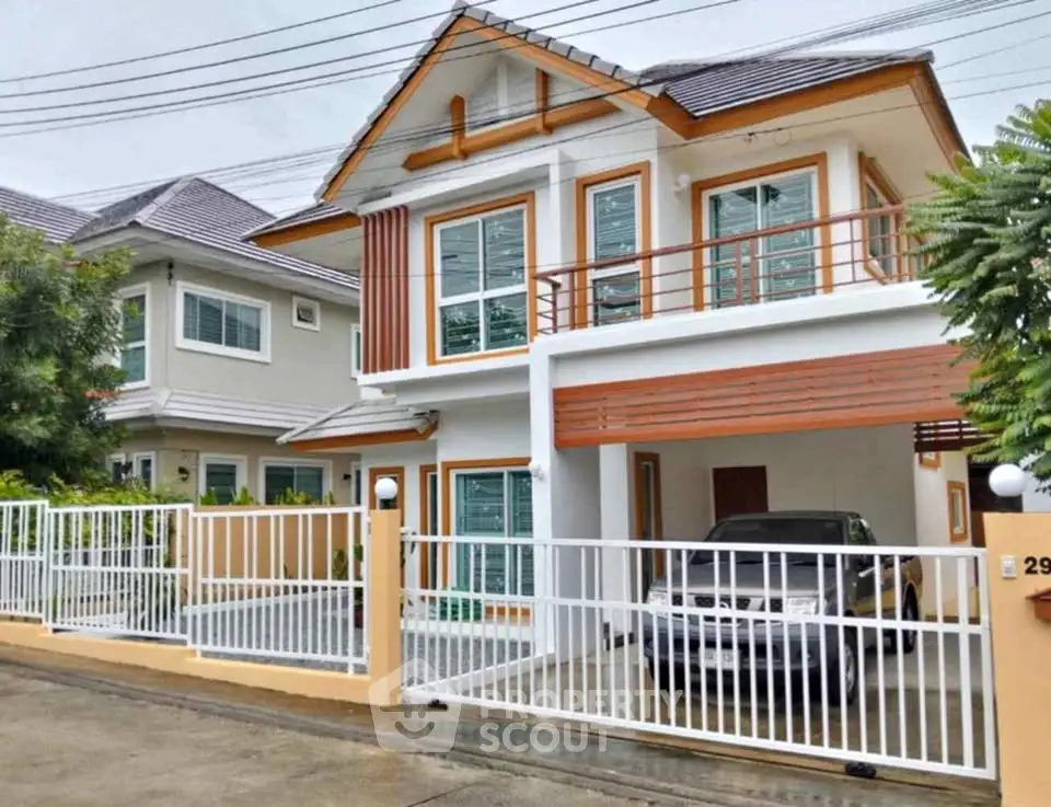 Charming two-story house with modern design and spacious carport in a serene neighborhood.
