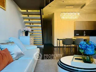 Luxurious modern living room with elegant staircase and chandelier