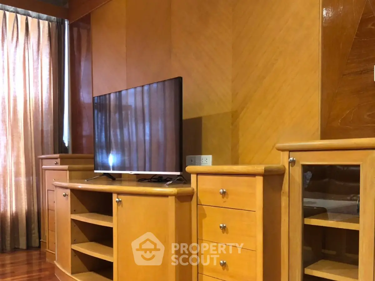 Elegant wooden entertainment center with TV in cozy living room