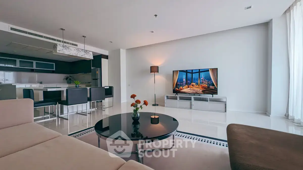 Spacious modern living room with sleek furniture and open kitchen layout, perfect for contemporary living.