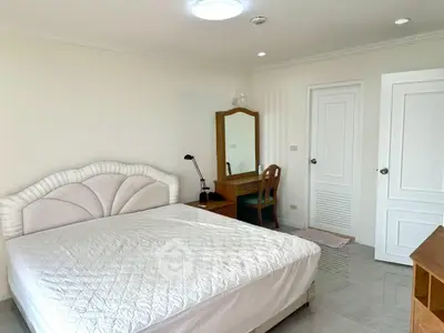 Spacious bedroom with elegant furniture and natural light