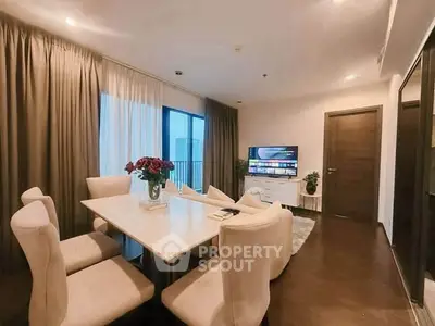 Elegant dining area with modern decor and large windows in a stylish apartment.