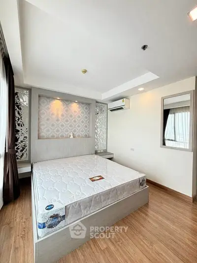 Modern bedroom with stylish decor and natural light, featuring a comfortable bed and elegant design.