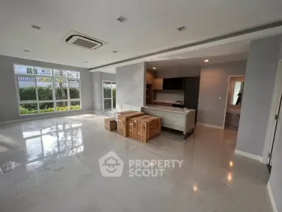 Spacious modern living room with open kitchen and large windows