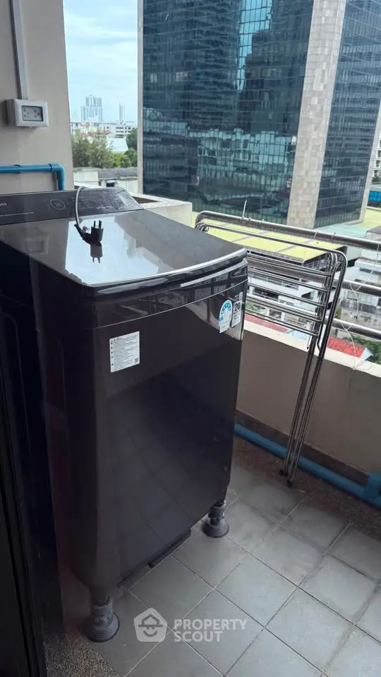 Modern balcony with washing machine and city view, perfect for urban living convenience.