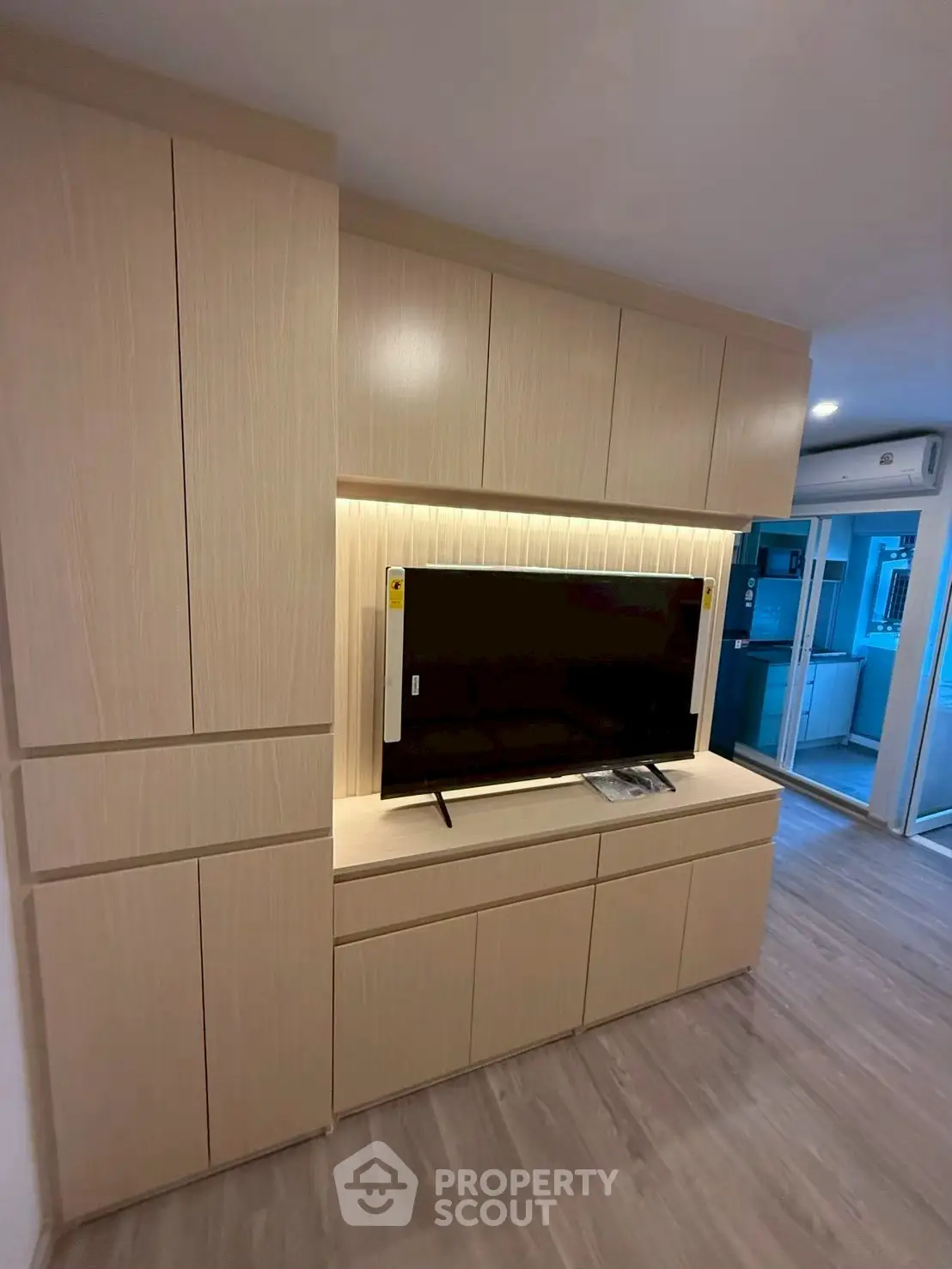 Modern living room with built-in wooden cabinets and sleek TV setup