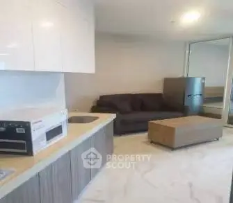 Modern apartment interior with sleek kitchen and cozy living area.
