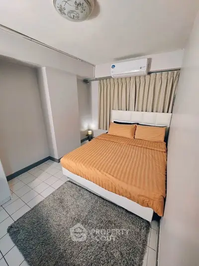 Cozy bedroom with modern air conditioning and stylish decor in a real estate property.