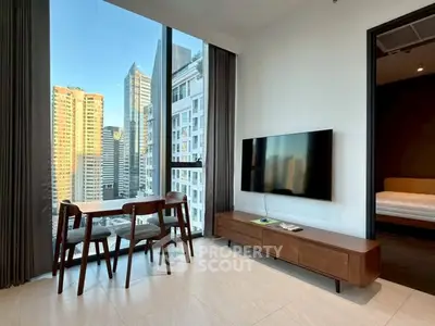 Modern living room with city view, sleek furniture, and large windows in urban apartment.