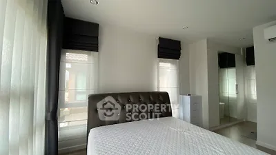 Spacious modern bedroom with elegant decor and ample natural light