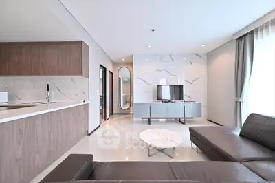 Modern open-plan living room with sleek kitchen and stylish decor