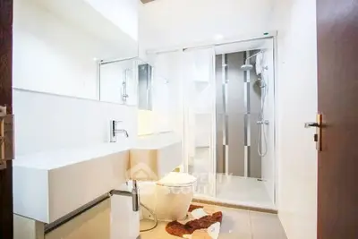Modern bathroom with sleek fixtures and glass shower enclosure