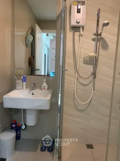 Modern bathroom with shower and sink in stylish apartment
