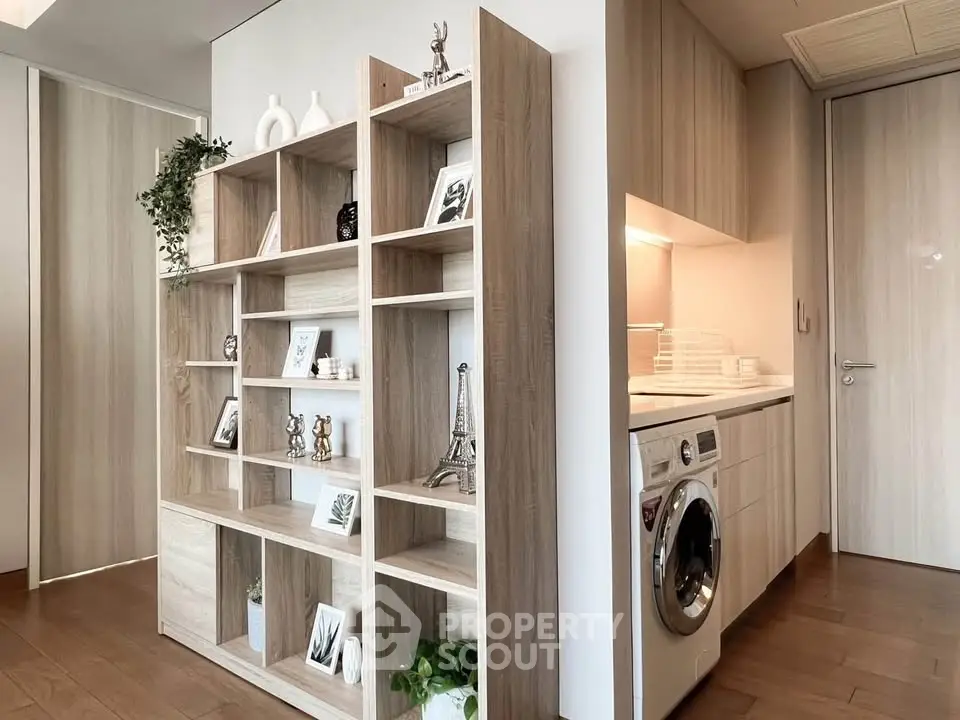 Modern apartment interior with stylish shelving and built-in washing machine
